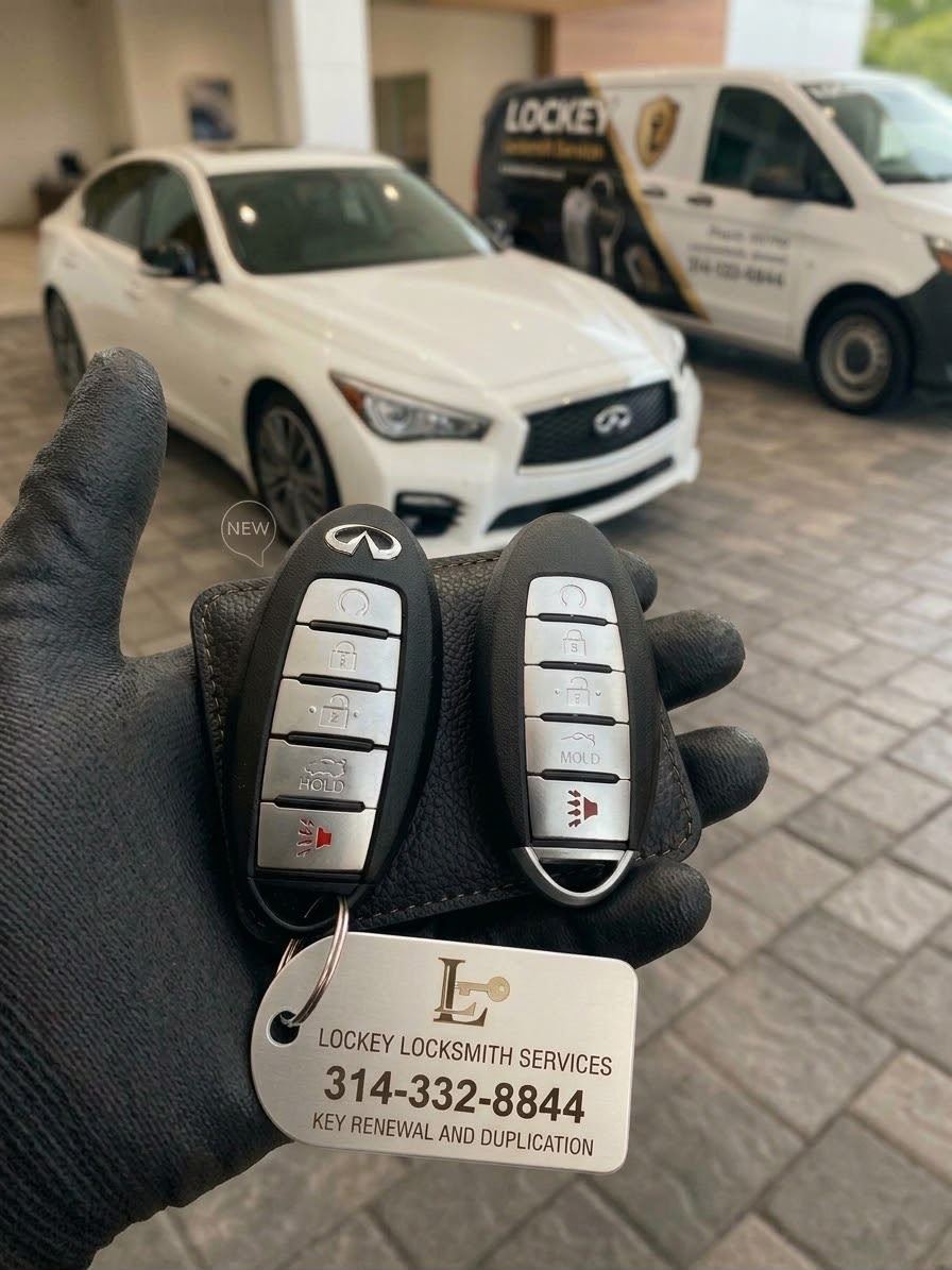 Two new Infiniti key fobs held in front of a Lockey van